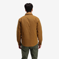 Back model shot of Topo Designs Men's Insulated Reversible Shirt Jacket in "dark khaki" brown