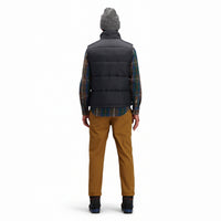 Back model shot of Topo Designs Men's Mountain Puffer recycled insulated Vest in "Black".