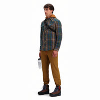 General side model shot of Topo Designs Men's Boulder lightweight climbing & hiking pants in "dark khaki" brown. 