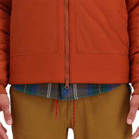 General detail shot of 2-way zipper on Topo Designs Mountain Puffer Primaloft insulated Hoodie jacket in "Brick" orange