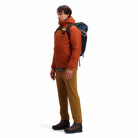 Side model shot of Topo Designs Men's Boulder lightweight climbing & hiking pants in "dark khaki" brown. 