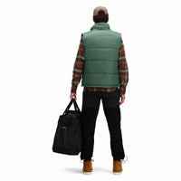 Back model shot of Topo Designs men's mountain organic cotton flannel shirt in "earth / tan plaid" brown