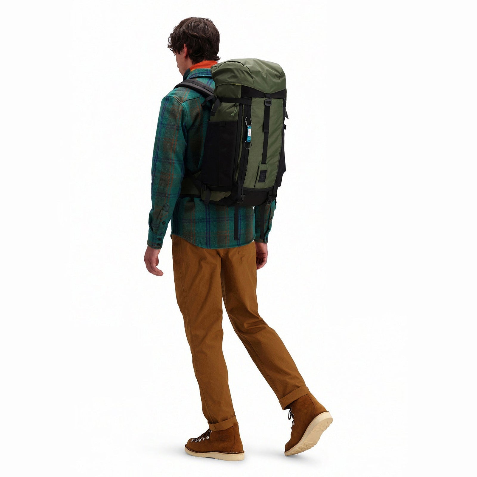 Model wearing Topo Designs Mountain Pack 28L hiking backpack with external laptop sleeve access in lightweight recycled "olive" green nylon.