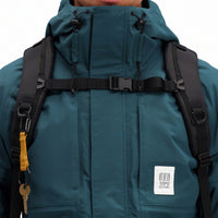 General front model shot showing chest pockets and logo patch on Topo Designs Men's Mountain Parka waterproof shell jacket in "Pond Blue"