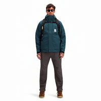 General front model shot of Topo Designs Men's Mountain Parka waterproof shell jacket in "Pond Blue"