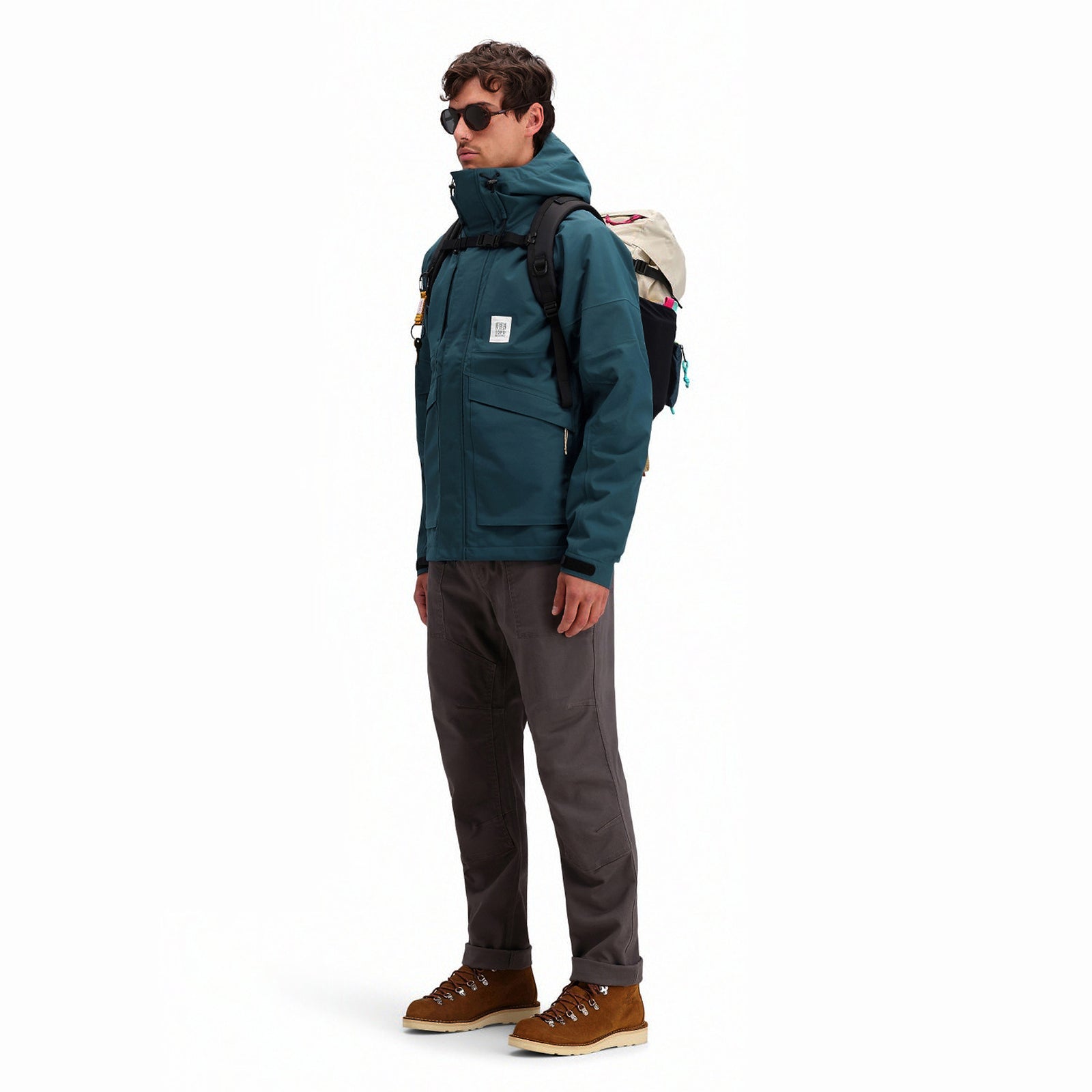 General side model shot of Topo Designs Men's Mountain Parka waterproof shell jacket in "Pond Blue"