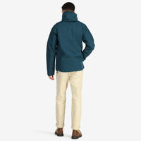 General back model shot of Topo Designs Men's Mountain Parka waterproof shell jacket in "Pond Blue"
