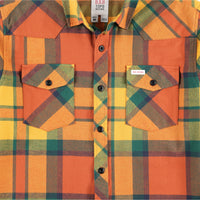 General detail shot of chest pockets on Topo Designs men's mountain organic cotton flannel shirt in "brick / mustard plaid" orange