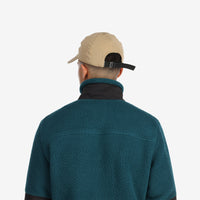 General back shot of Topo Designs Tech Cap 6-panel nylon hat in "dark khaki" brown on model.