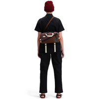 Back model shot of Topo Designs Women's Dirt Coverall 100% organic cotton short sleeve jumpsuit in "black"