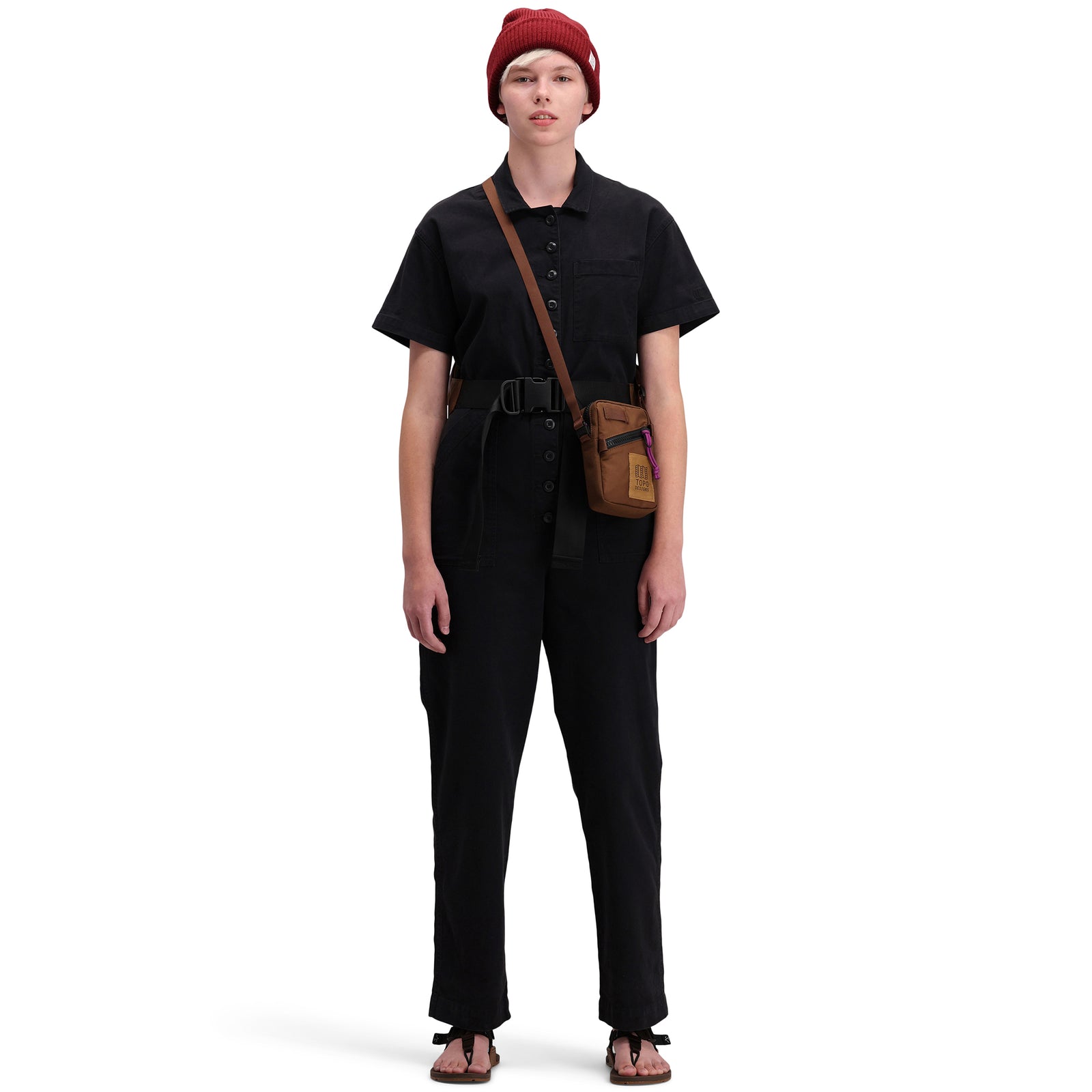 Front model shot of Topo Designs Women's Dirt Coverall 100% organic cotton short sleeve jumpsuit in "black"