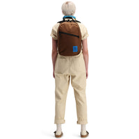 Back model shot of Topo Designs Women's Dirt Coverall 100% organic cotton short sleeve jumpsuit in "sand" white