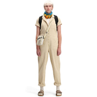 Front model shot of Topo Designs Women's Dirt Coverall 100% organic cotton short sleeve jumpsuit in "sand" white