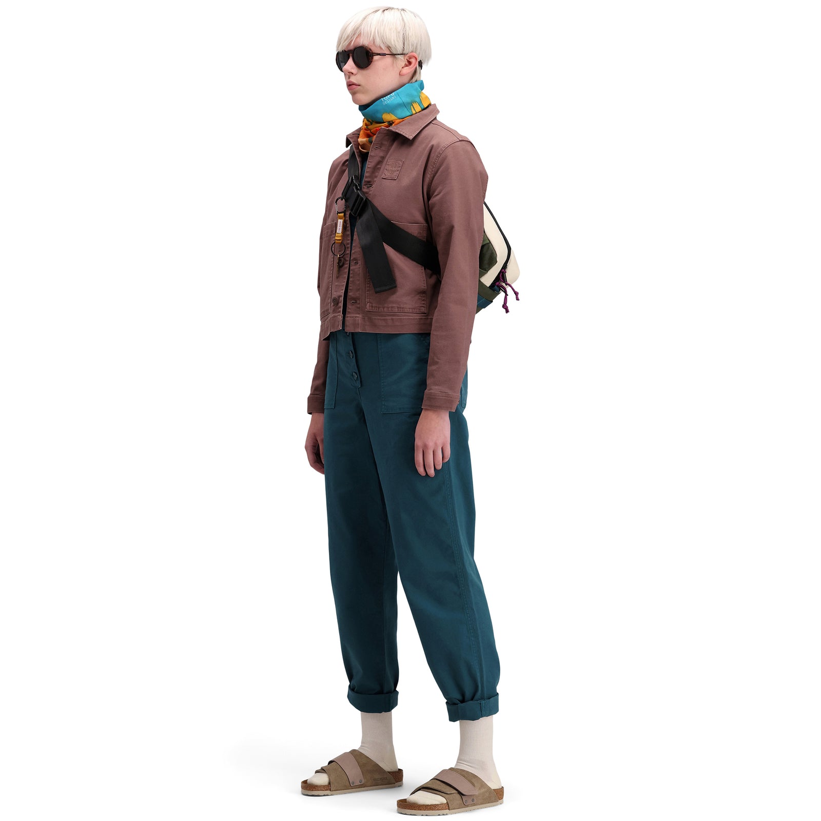 Side model shot of Topo Designs Women's Dirt Coverall 100% organic cotton short sleeve jumpsuit in "pond blue"
