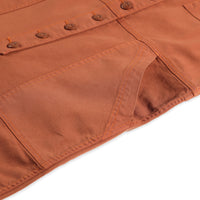 General detail shot of front pockets on Topo Designs Women's Dirt Coverall 100% organic cotton short sleeve jumpsuit in "brick" orange