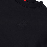 General detail shot of embroidered chest logo on Topo Designs Women's Dirt Crew sweatshirt in 100% organic cotton French terry in "black"