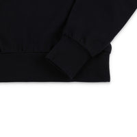 General detail shot of sleeve cuff and bottom hem on Topo Designs Women's Dirt Crew sweatshirt in 100% organic cotton French terry in "black"