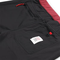General detail shot of back pockets on Topo Designs Women's Fleece Pants in "Burgundy / Black"