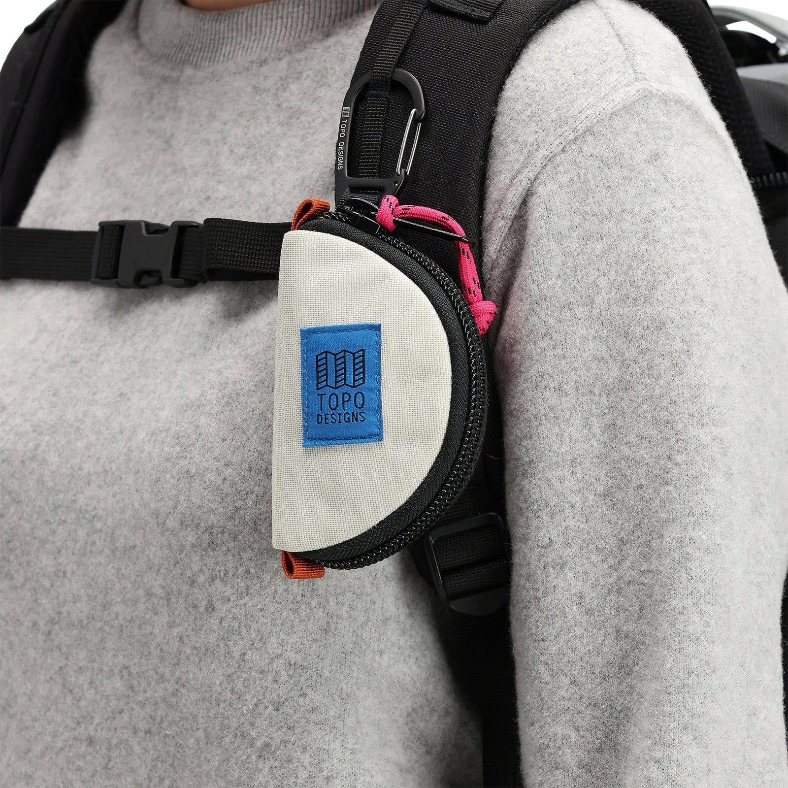 General model shot of Topo Designs Taco Bag carabiner key clip keychain bag in "Bone White" nylon.