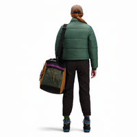 Back model shot of Topo Designs Women's Puffer recycled insulated Jacket in "Forest" green.