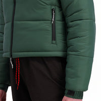 Front model shot of Topo Designs Women's Puffer recycled insulated Jacket in "Forest" green showing zipper hand pocket.