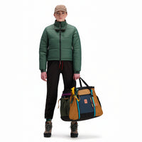 Front model shot of Topo Designs Women's Puffer recycled insulated Jacket in "Forest" green.