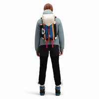 Back model shot of Topo Designs Mountain Pack 16L hiking backpack with internal laptop sleeve in lightweight recycled nylon "Bone White / Blue".