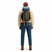 Back model shot of Topo Designs Mountain Pack 16L hiking backpack with internal laptop sleeve in lightweight recycled nylon "Pond Blue / Olive" green. Show on "Hemp / Bone Brown" and "Red / Turquoise"