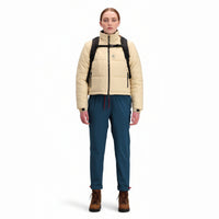 Front model shot of Topo Designs Women's Puffer recycled insulated Jacket in "Sand" white.
