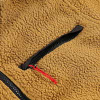 General detail shot of chest zipper pocket on Topo Designs Women's Mountain Fleece Pullover in "dark khaki" brown