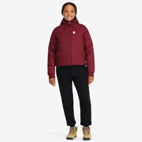 Front model shot of Topo Designs Women's Puffer Primaloft insulated Hoodie jacket in "burgundy" red.