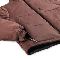 Detail shot of hand zipper pocket on Topo Designs Women's Puffer recycled insulated Jacket in "Peppercorn" purple brown.