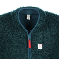 General detail shot of collar and zipper on Topo Designs Women's sherpa fleece reversible jacket in "Pond Blue"