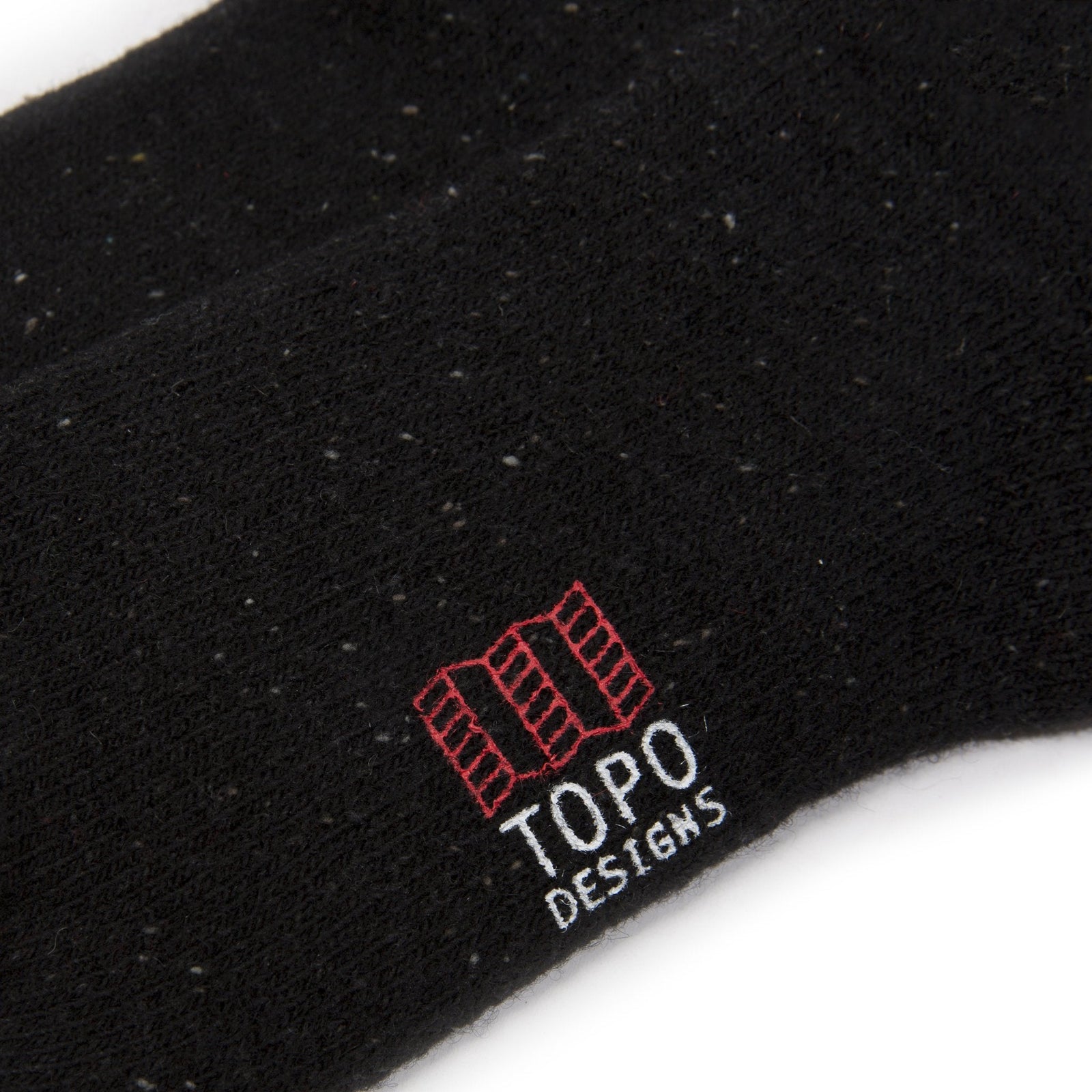 Detail shot of mountain socks in "black" showing logo.