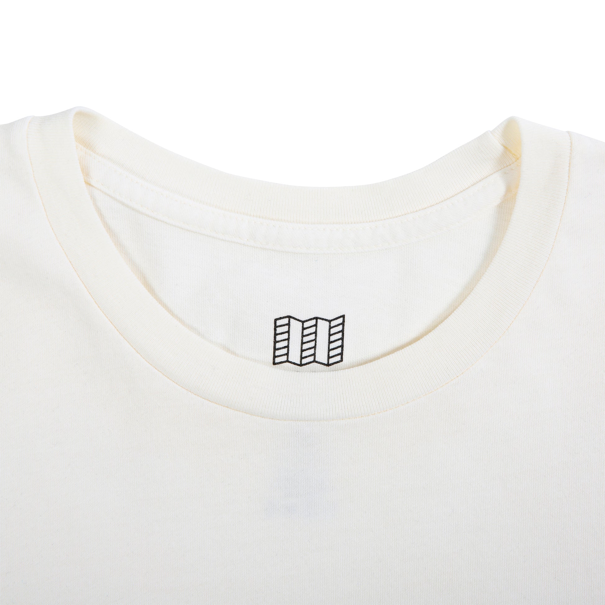 Detail product shot of Topo Designs x New Balance Graphic tee long sleeve in natural showing the neck hemline