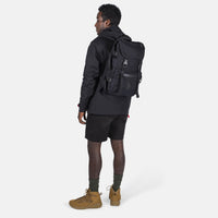 Model shot of the Topo Designs Rover Pack Tech external access laptop backpack in "Black".