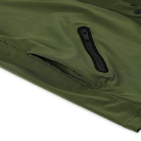 General shot of front hand slip and zipper pocket on Topo Designs Men's Tech Breaker Jacket 4-way stretch windbreaker in olive green.
