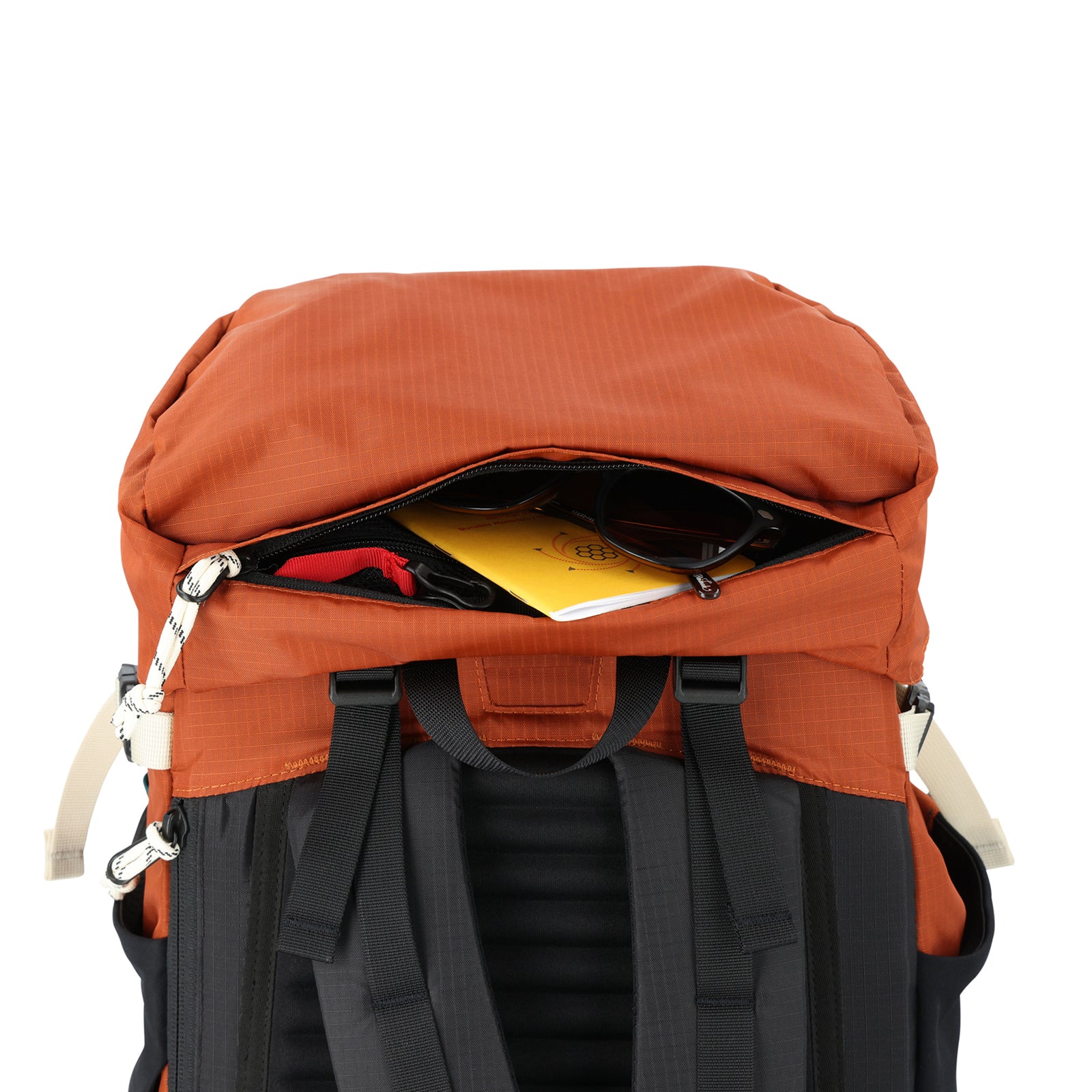General shot of top zipper compartment and key clip on Topo Designs Mountain Pack 28L hiking backpack with external laptop sleeve access in lightweight recycled clay orange black nylon.