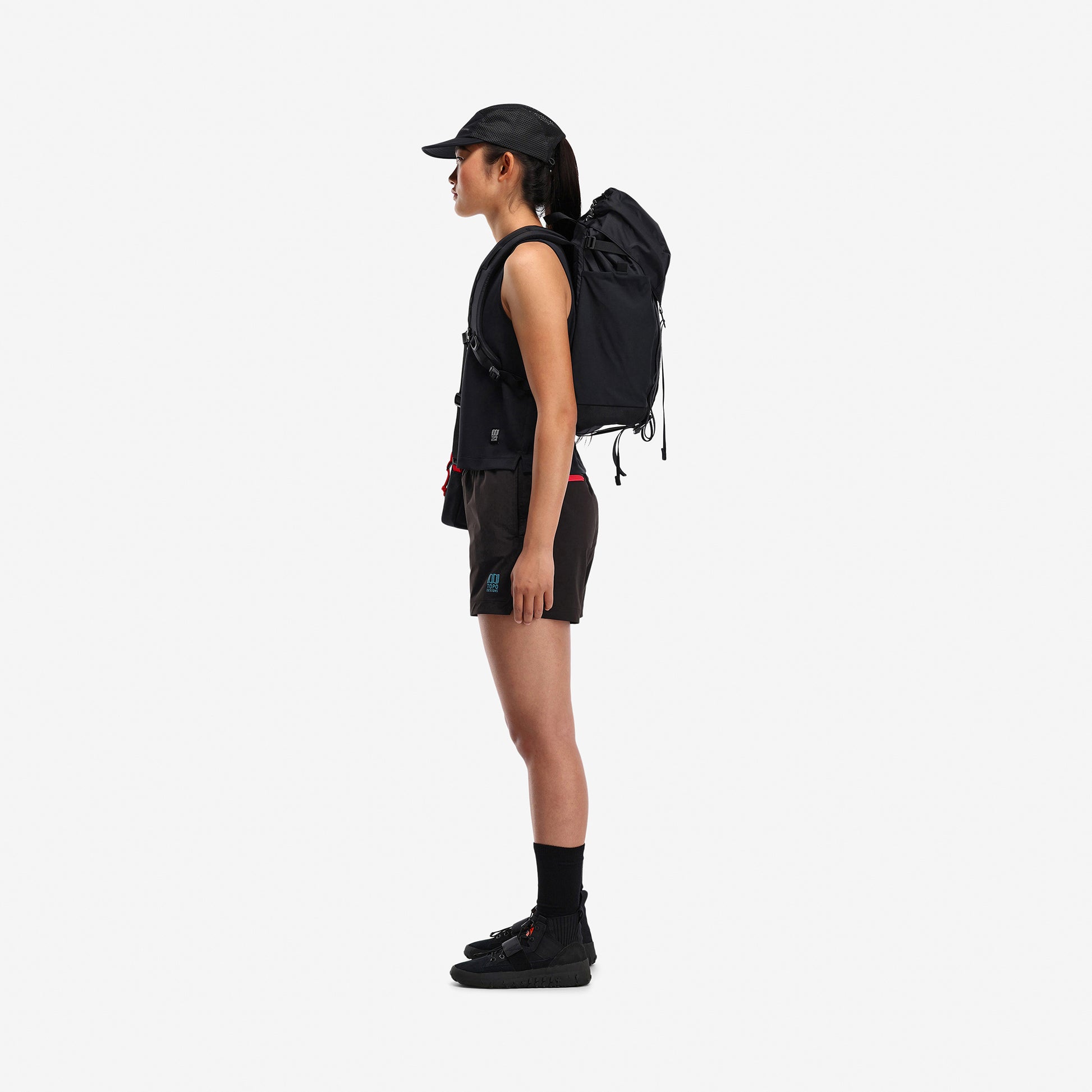 Side model shot of Topo Designs Women's Global lightweight quick dry travel Shorts in "Black"