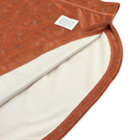 General shot of inside fabric of Topo Designs Women's River Hoodie 30+ UPF rated moisture wicking water shirt in clay orange terrazzo print.