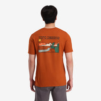 On model back view of Topo Designs Men's Cactus Landscape Tee 100% organic cotton short sleeve graphic logo t-shirt in "clay" orange.