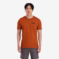 On model front view of Topo Designs Men's Cactus Landscape Tee 100% organic cotton short sleeve graphic logo t-shirt in "clay" orange.