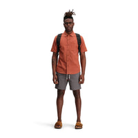 General shot of Topo Designs Men's Short Sleeve Dirt Shirt in "Brick" orange on model.