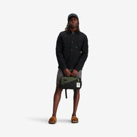 Model shot of Topo Designs Men's Dirt shirt Jacket 100% organic cotton in "Black".