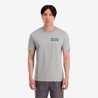 On model front view Topo Designs Men's Geographic Tee 100% organic cotton short sleeve graphic logo t-shirt in "gray".