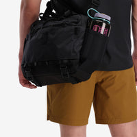 Side view of water bottle holder for the Topo Designs Mountain Cross Bag in recycled "Black" nylon.