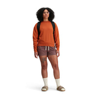 Model shot of Topo Designs Women's Dirt Crew sweatshirt in 100% organic cotton French terry in "Brick" orange.