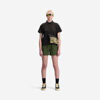 On model front view photo of Topo Designs Women's Global Shirt Short Sleeve 30+ UPF rated travel shirt in "Black".