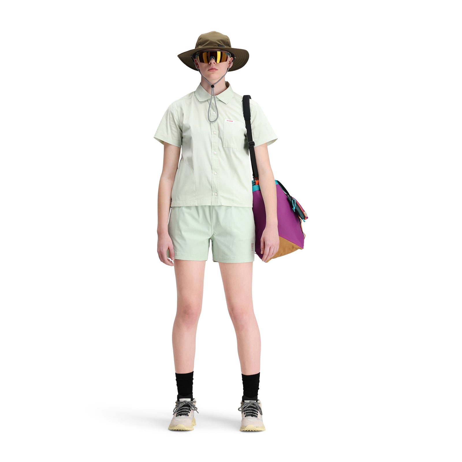 Front model shot of Topo Designs Women's Global Shirt Short Sleeve 30+ UPF rated travel shirt in "Light Mint" green.