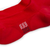 Detail shot of Topo Designs Town Socks in "Red" showing logo.
